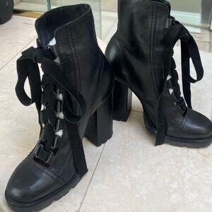 Schutz tie up booties w suede laces. Never worn but has a few scuffs on heals